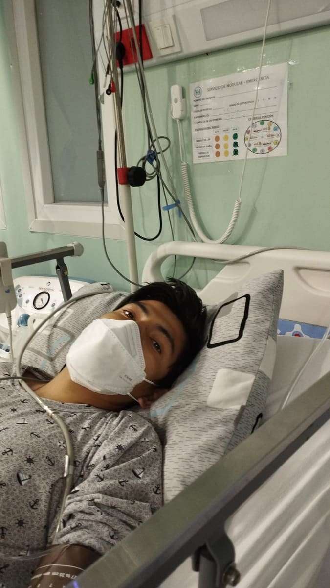 Joseph acostado con mascarilla en una cama de hospital